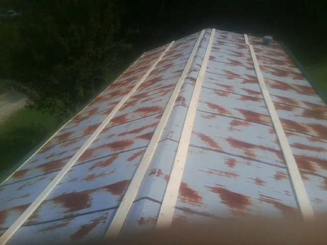 Rusted metal roof panels with new wood purlins before replacement — Storm Damage Roof Repair in Deer Park by Roofing Brothers