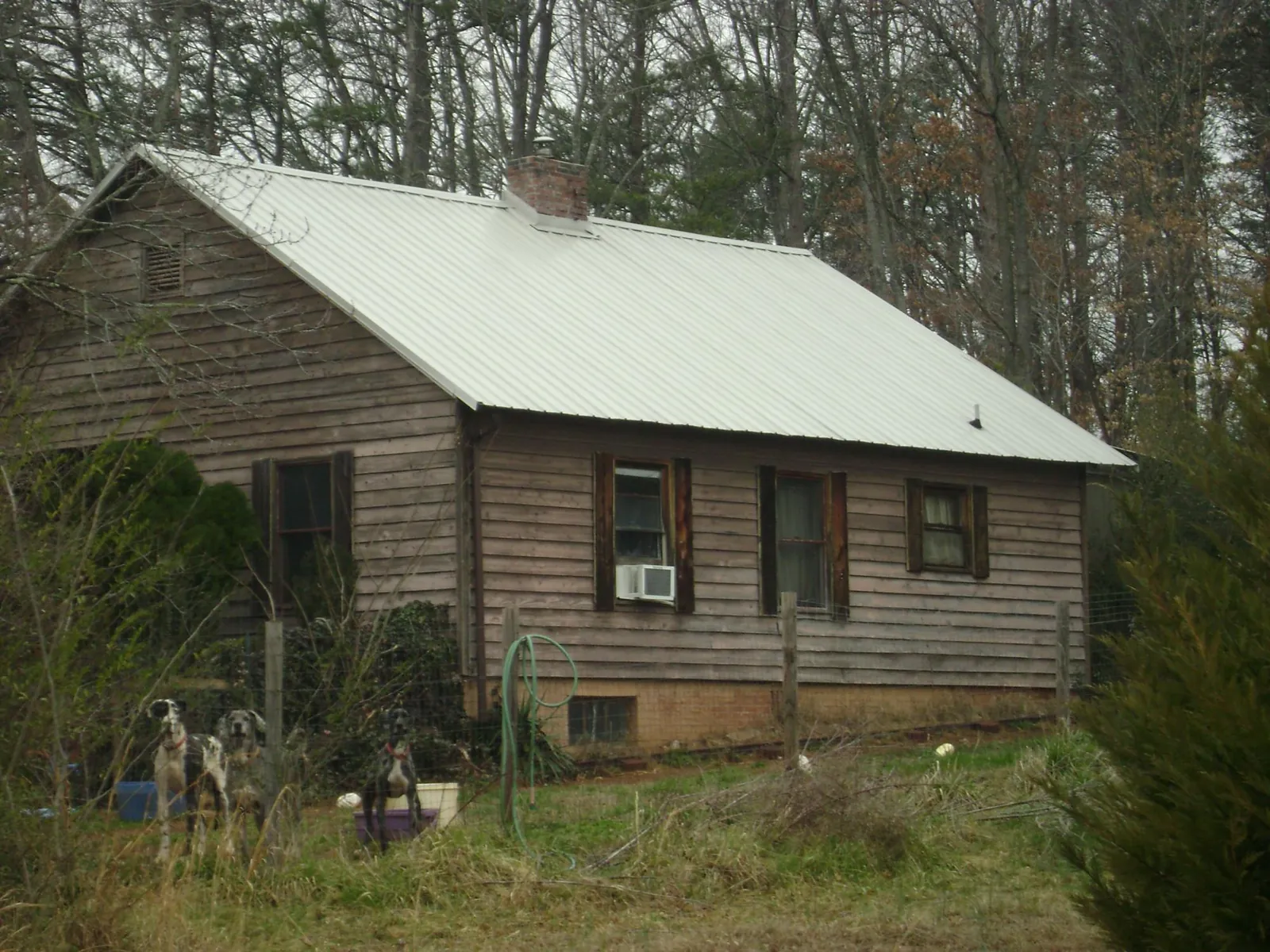 White metal roof on an old wood sided farmhouse, from a Metal Roof Installation job in Deer Park
